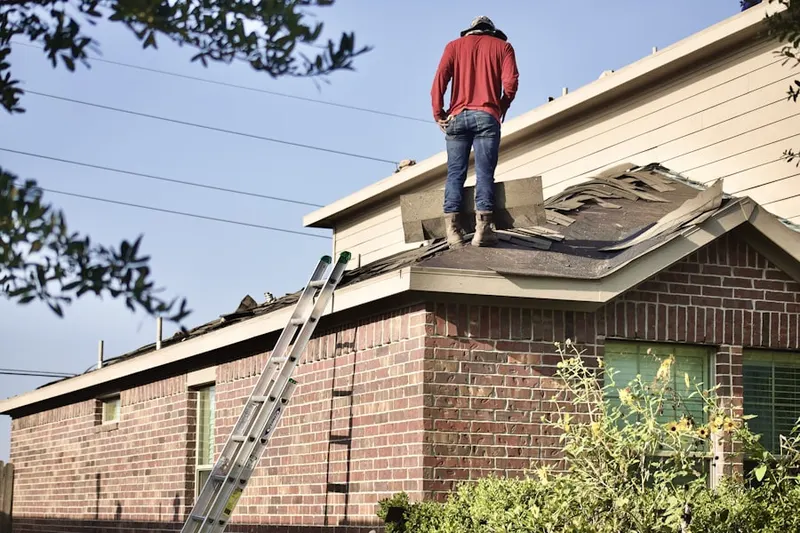 Professional roofer working on a residential roof in Mill Lane